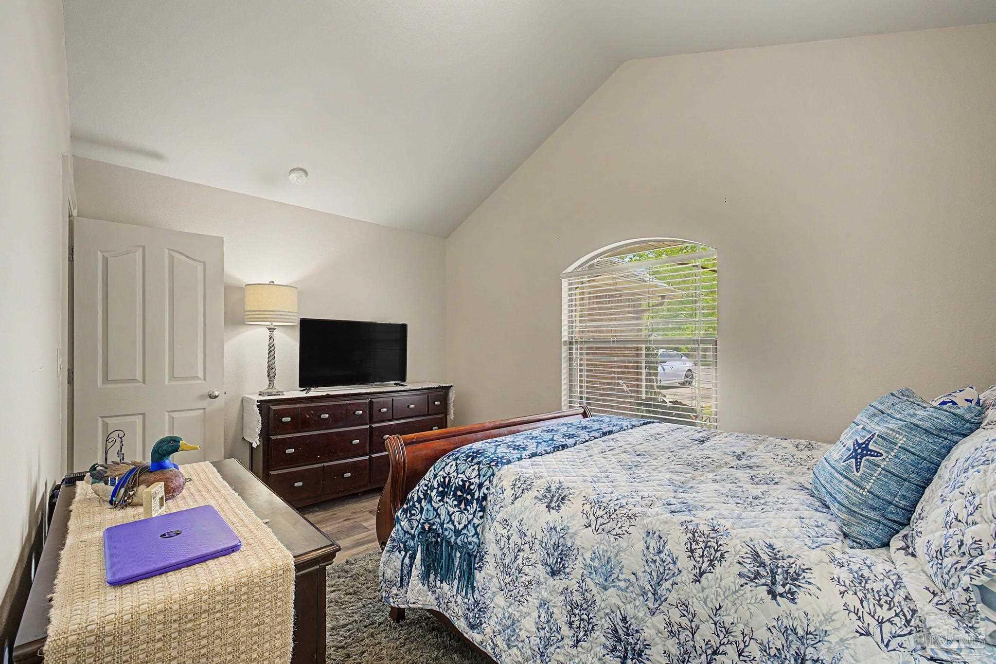 5461 Tucker Circle Pace, FL 32571 - Photo 28 of 52 a bedroom with a bed and a flat screen tv
