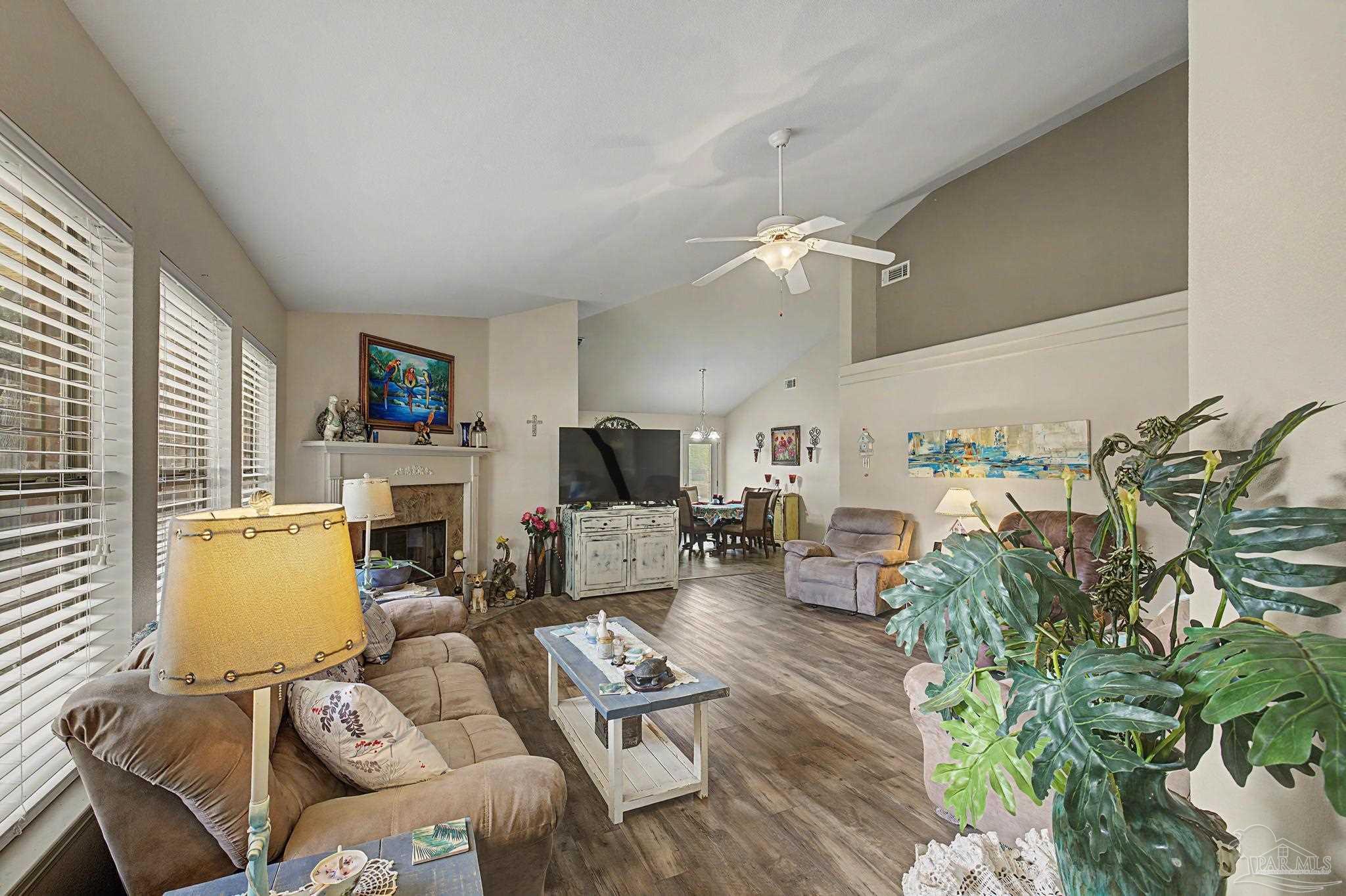 5461 Tucker Circle Pace, FL 32571 - Photo 3 of 52 a living room with furniture and a flat screen tv