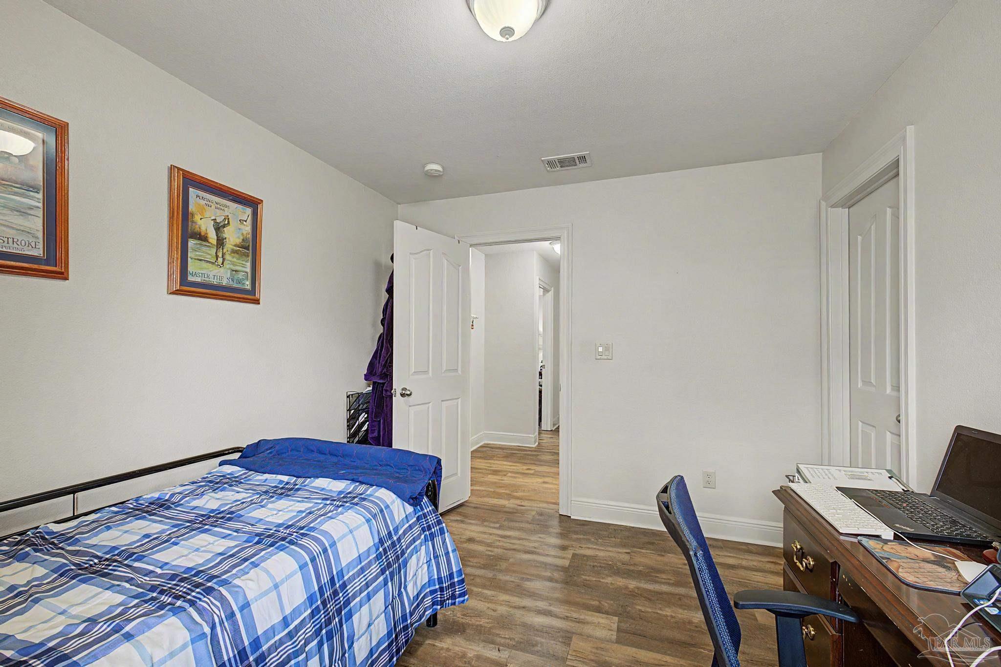 5461 Tucker Circle Pace, FL 32571 - Photo 31 of 52 a bedroom with a bed and a desk