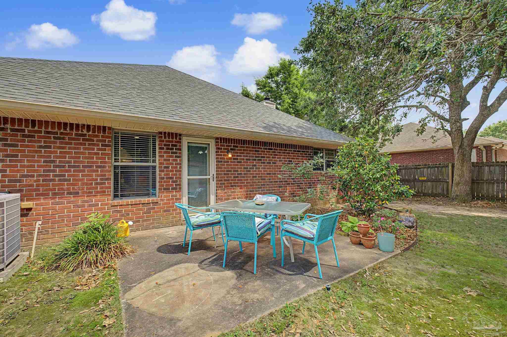 5461 Tucker Circle Pace, FL 32571 - Photo 33 of 52 a view of a house with backyard sitting area and garden