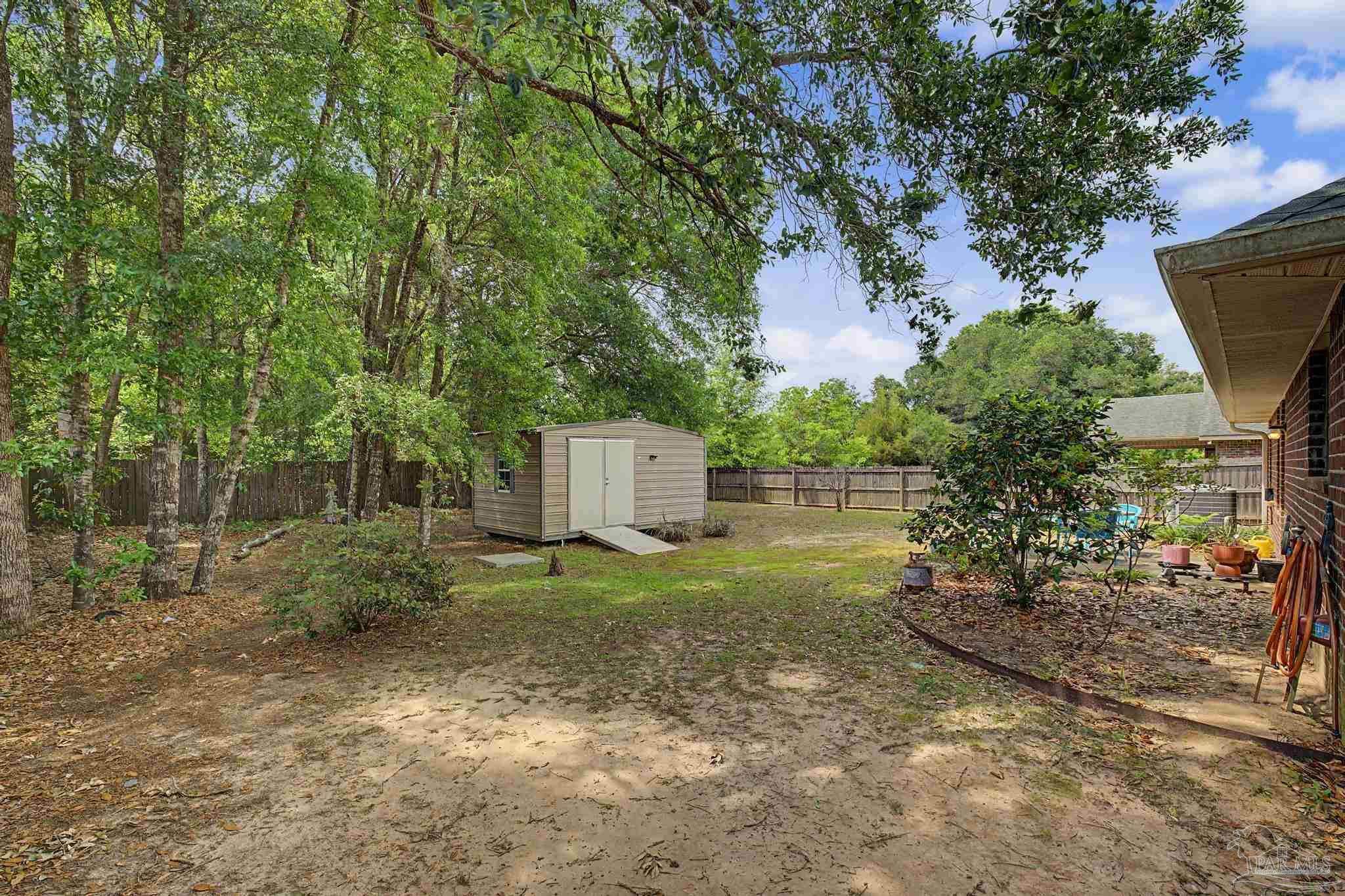 5461 Tucker Circle Pace, FL 32571 - Photo 35 of 52 a backyard of a house with lots of green space