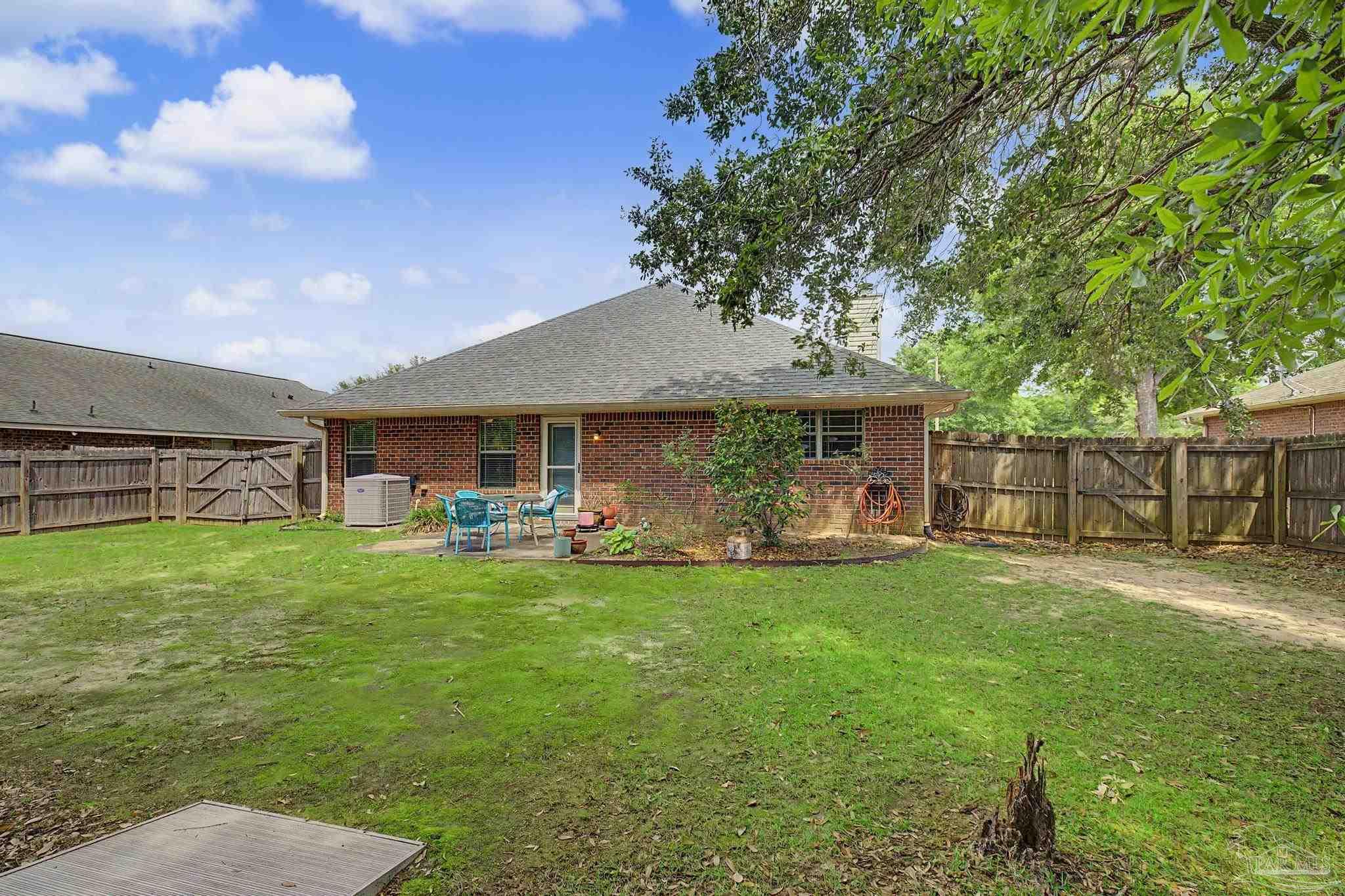 5461 Tucker Circle Pace, FL 32571 - Photo 37 of 52 a view of a house with a yard porch and sitting area