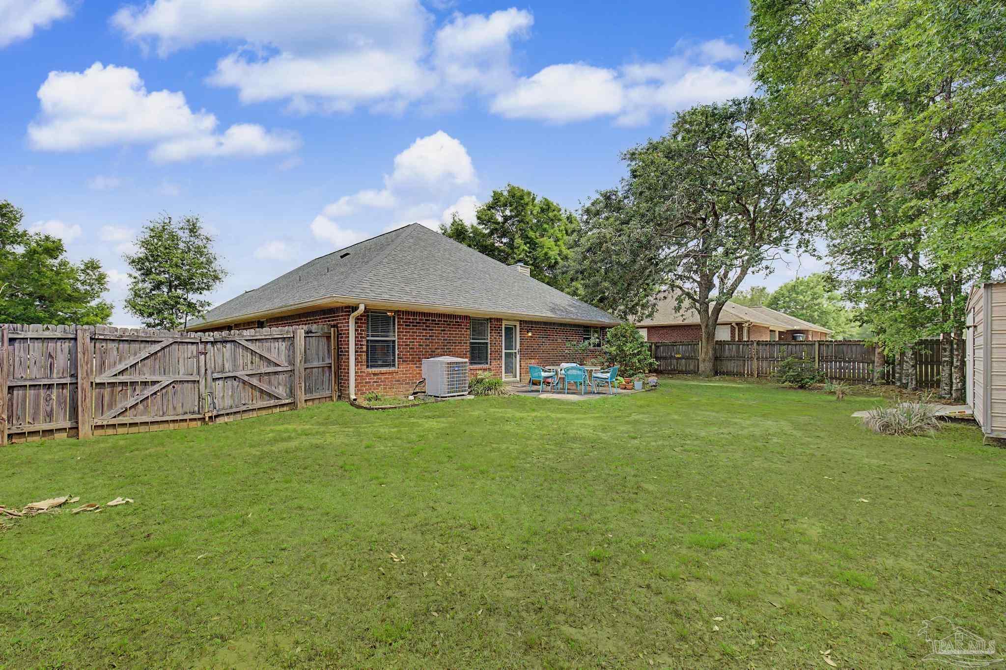 5461 Tucker Circle Pace, FL 32571 - Photo 40 of 52 a front view of a house with garden