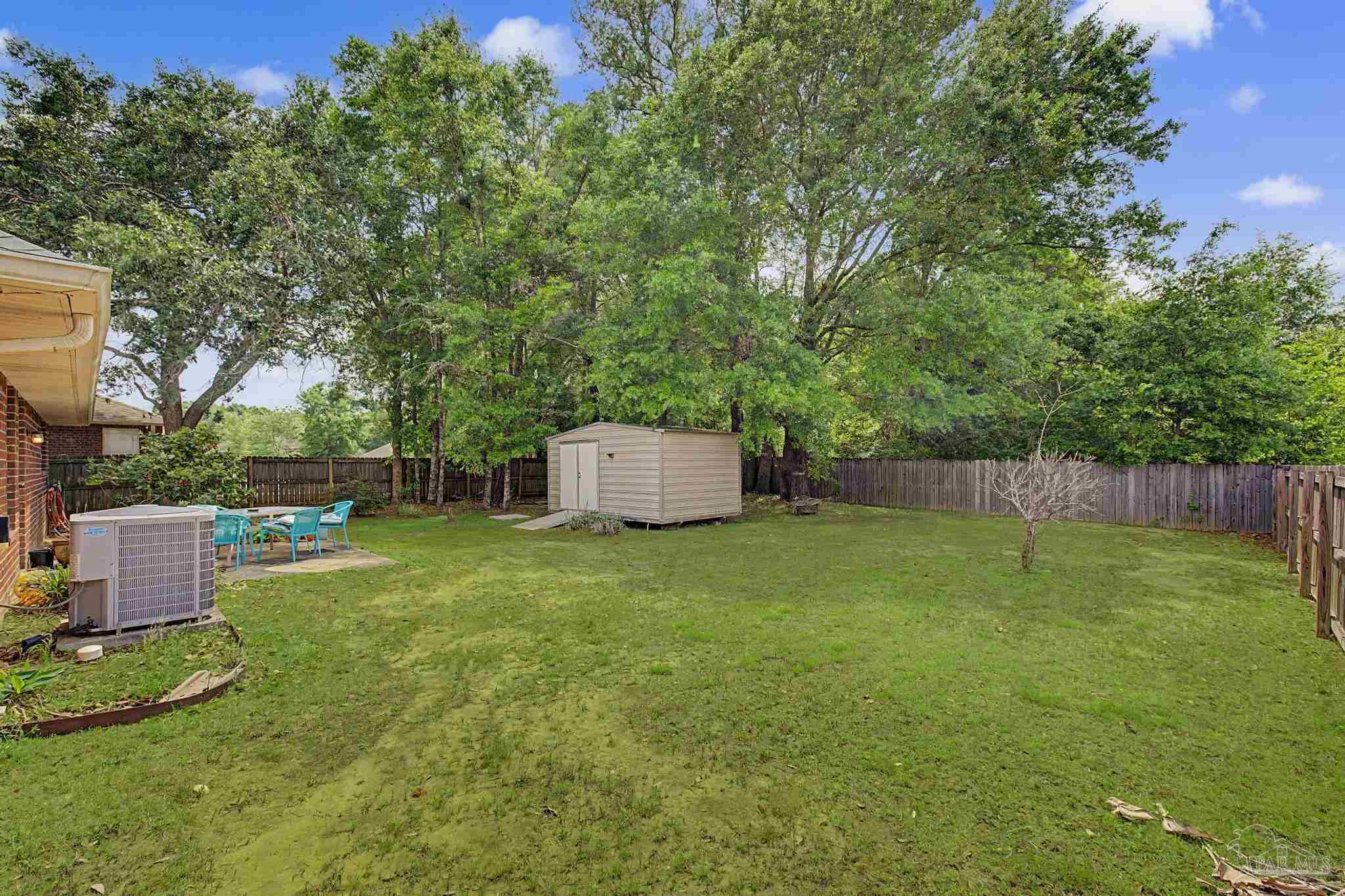 5461 Tucker Circle Pace, FL 32571 - Photo 41 of 52 a backyard of a house with lots of green space