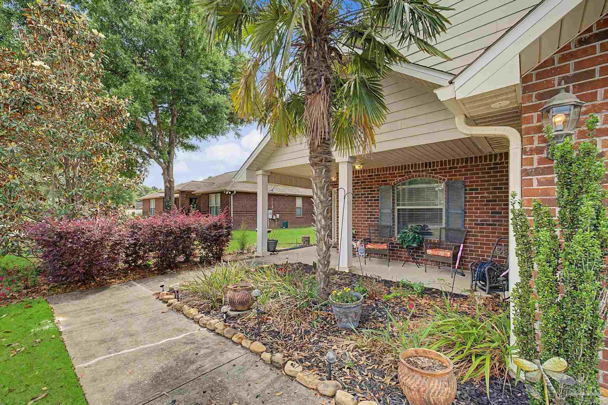 5461 Tucker Circle Pace, FL 32571 - Photo 42 of 52 a front view of house with a garden