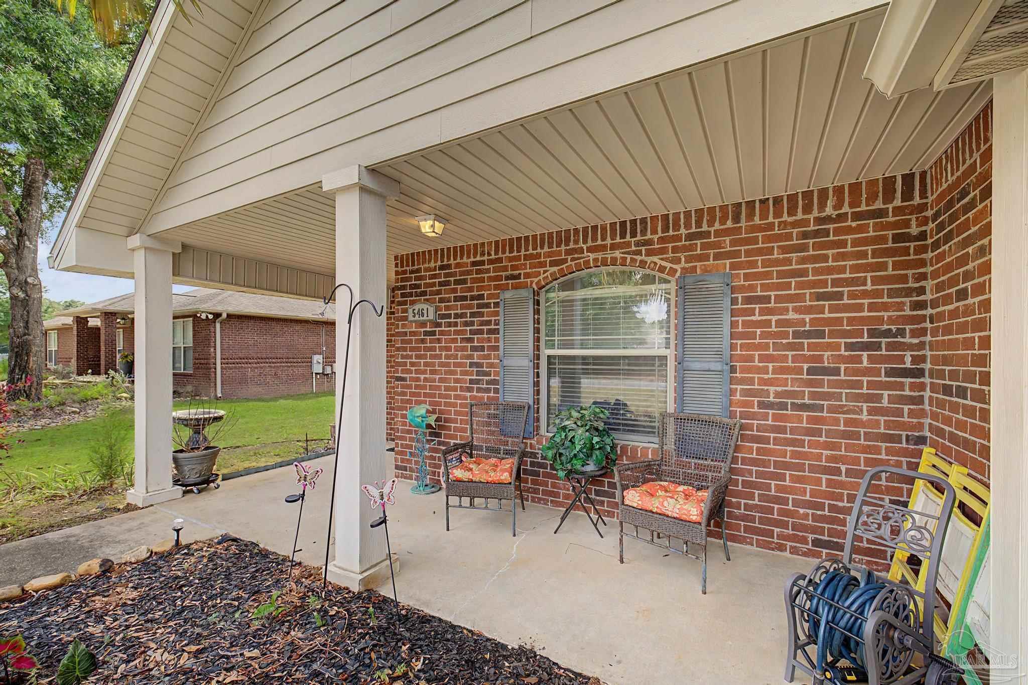 5461 Tucker Circle Pace, FL 32571 - Photo 44 of 52 a backyard of a house with outdoor seating