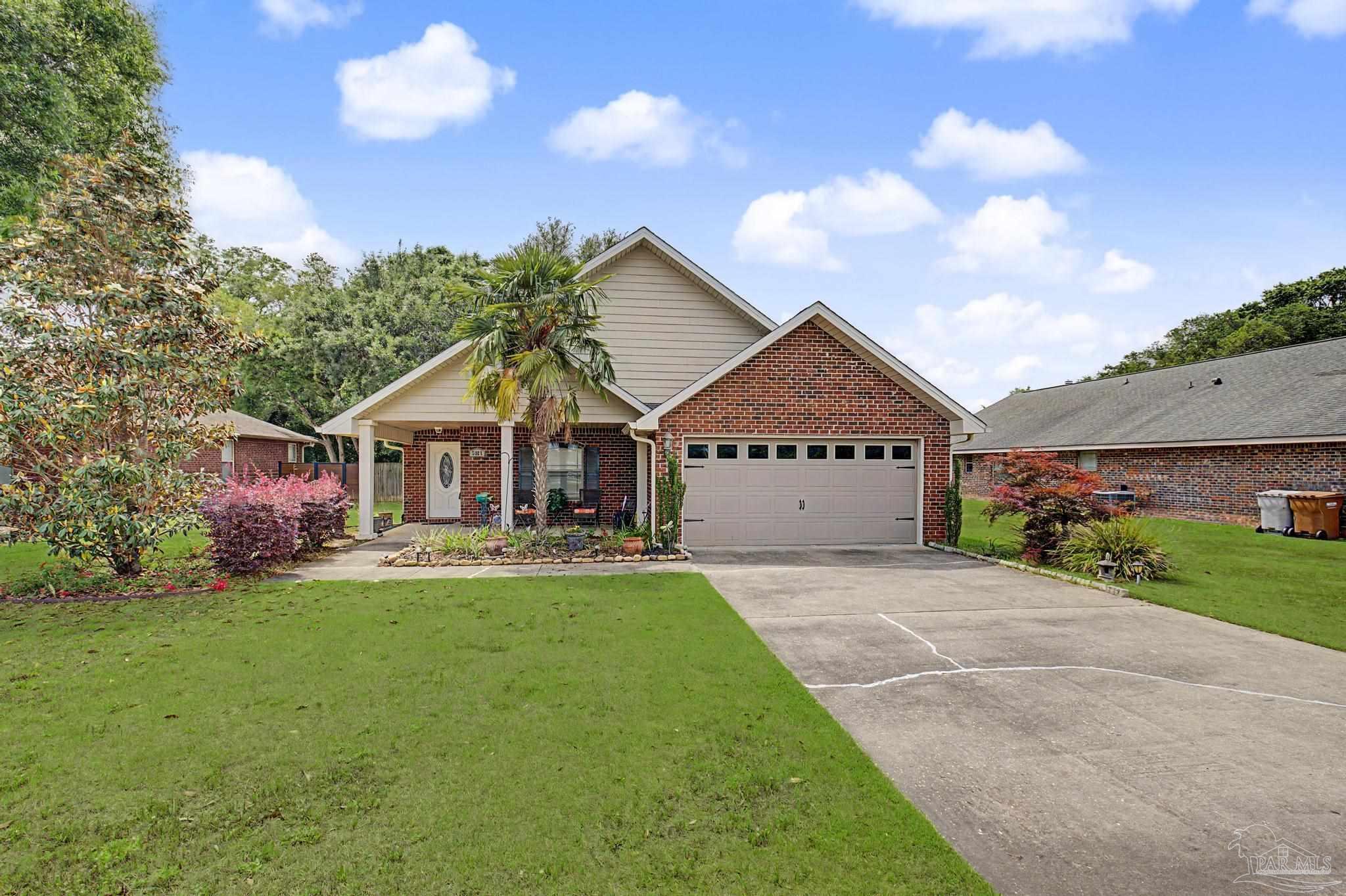 5461 Tucker Circle Pace, FL 32571 - Photo 48 of 52 a front view of a house with a yard and garage