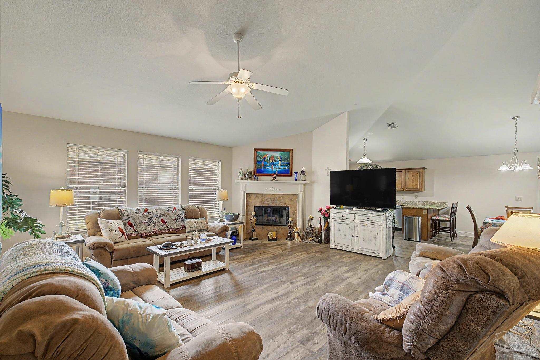 5461 Tucker Circle Pace, FL 32571 - Photo 5 of 52 a living room with furniture and a flat screen tv