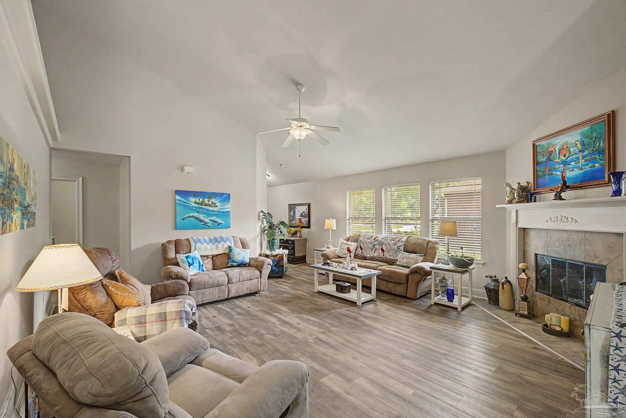 5461 Tucker Circle Pace, FL 32571 - Photo 6 of 52 a living room with furniture and a fireplace