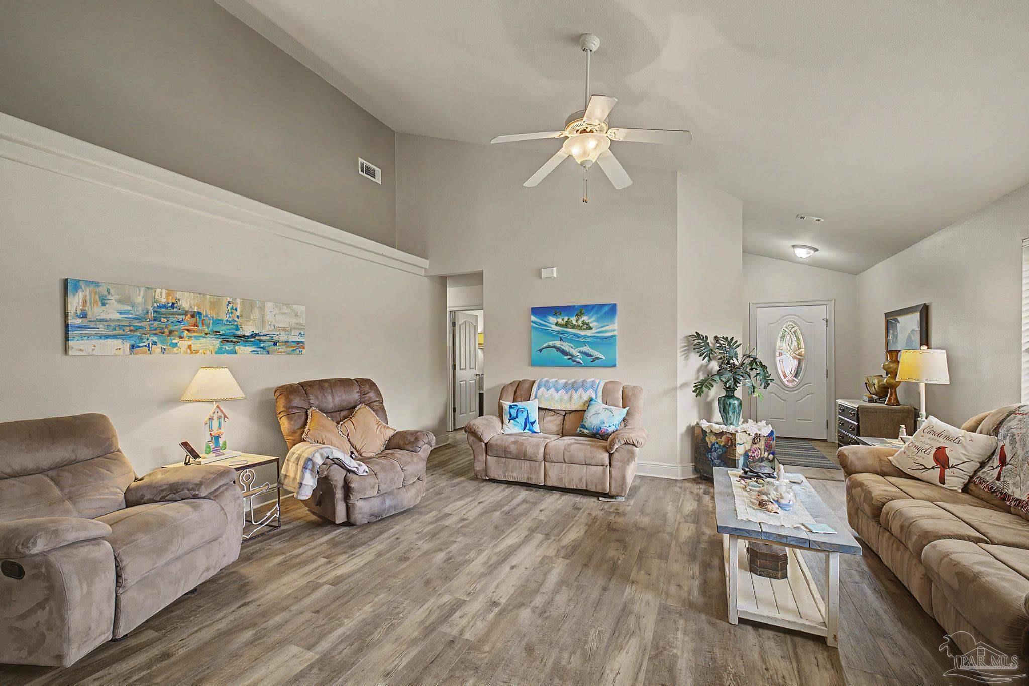 5461 Tucker Circle Pace, FL 32571 - Photo 8 of 52 a living room with furniture and a wooden floor