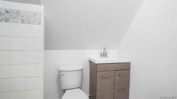 a view of a refrigerator in kitchen and cabinets