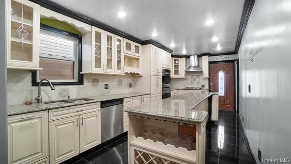 a kitchen with stainless steel appliances granite countertop a sink stove and refrigerator