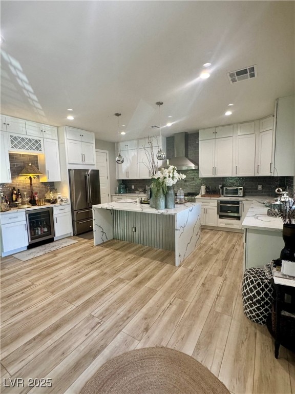 Kitchen with decorative backsplash, pendant lighting, white cabinetry, light stone countertops, and recessed lighting