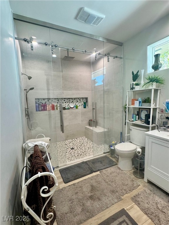 251 Spring Heights Caliente, NV 89008 - Photo 11 of 19 Full bathroom with vanity, light wood finished floors, and a stall shower