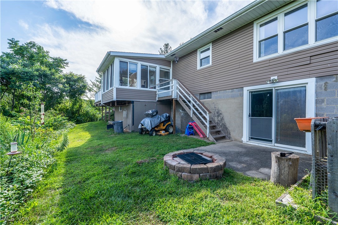 659 Lake Road Conneaut, OH 44030 - Photo 22 of 24 Back of property featuring a patio, a sunroom, and a yard