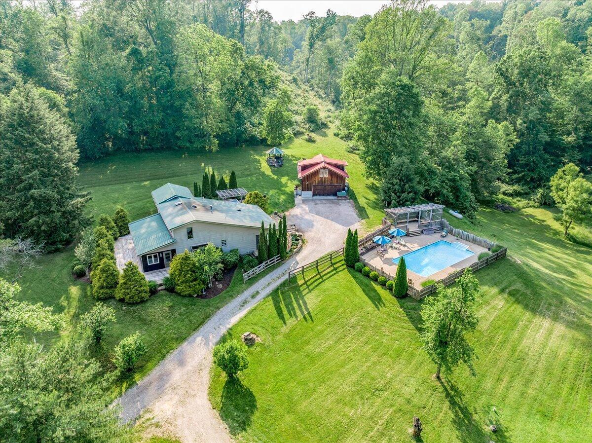 drone view of home, garage and pool