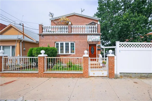 a view of a house with a small yard and a large window