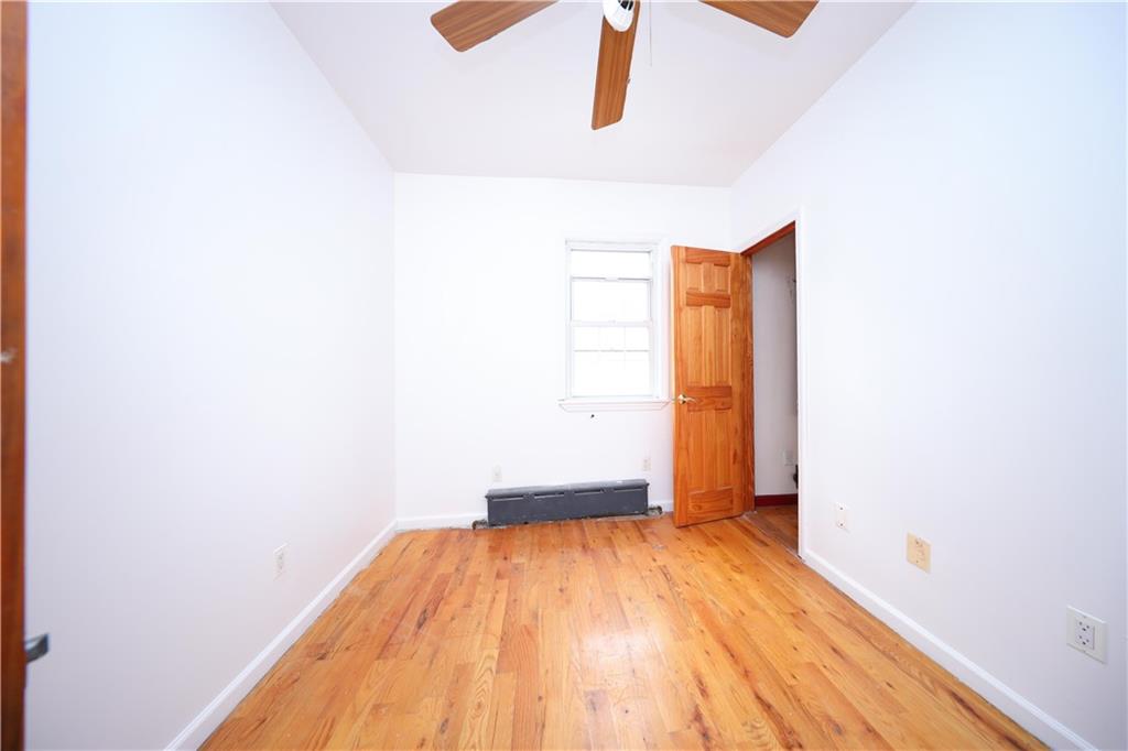 2667 Cropsey Avenue Brooklyn, NY 11214 - Photo 15 of 40 a view of a room with wooden floor and a window