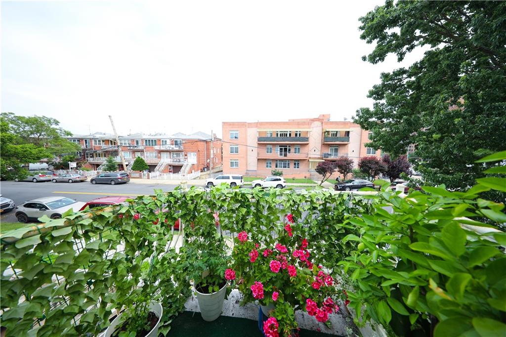 2667 Cropsey Avenue Brooklyn, NY 11214 - Photo 17 of 40 a view of a garden with a building and couple of cars parked in it