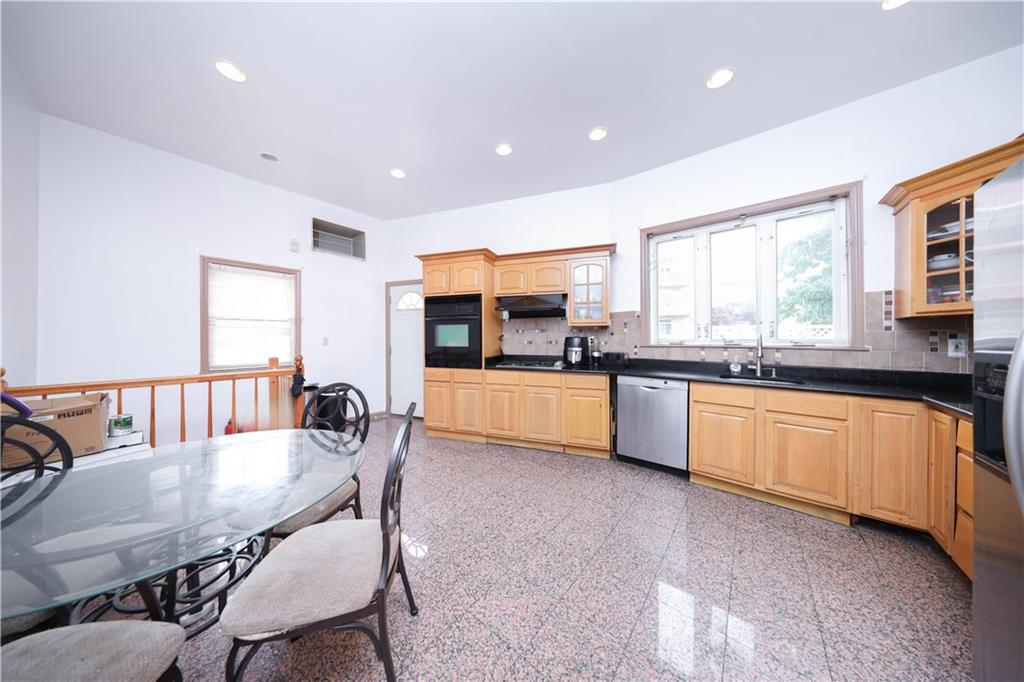 2667 Cropsey Avenue Brooklyn, NY 11214 - Photo 24 of 40 a kitchen with stainless steel appliances kitchen island granite countertop a sink and cabinets