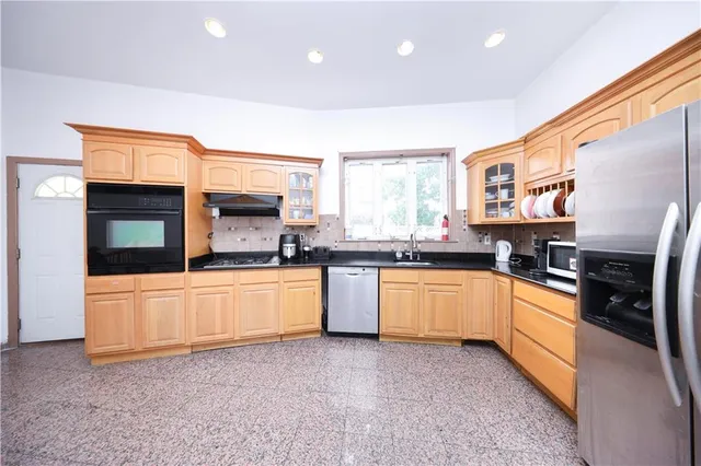 a white kitchen with stainless steel appliances