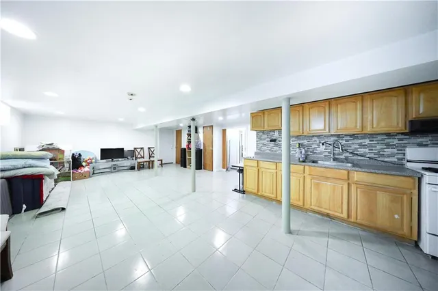 a large bathroom with a granite countertop tub sink and cabinets