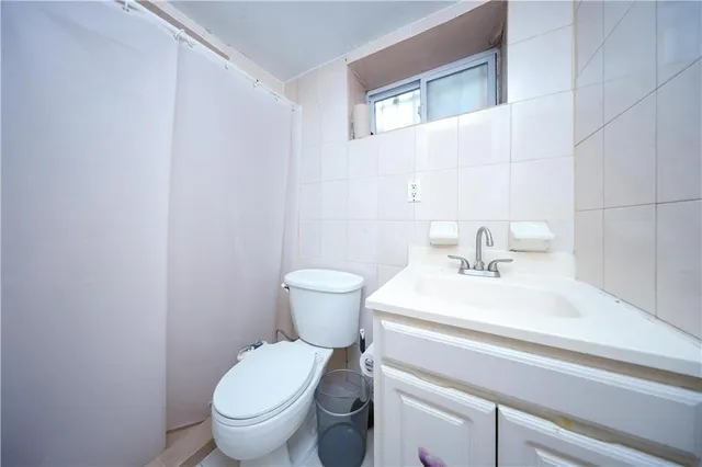 a bathroom with a sink toilet and a mirror