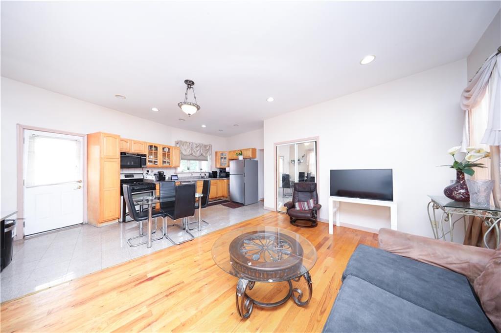 2667 Cropsey Avenue Brooklyn, NY 11214 - Photo 8 of 40 a living room with furniture and a flat screen tv