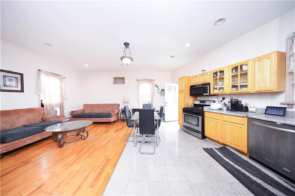 2667 Cropsey Avenue Brooklyn, NY 11214 - Photo 9 of 40 a living room with furniture flat screen tv and kitchen view