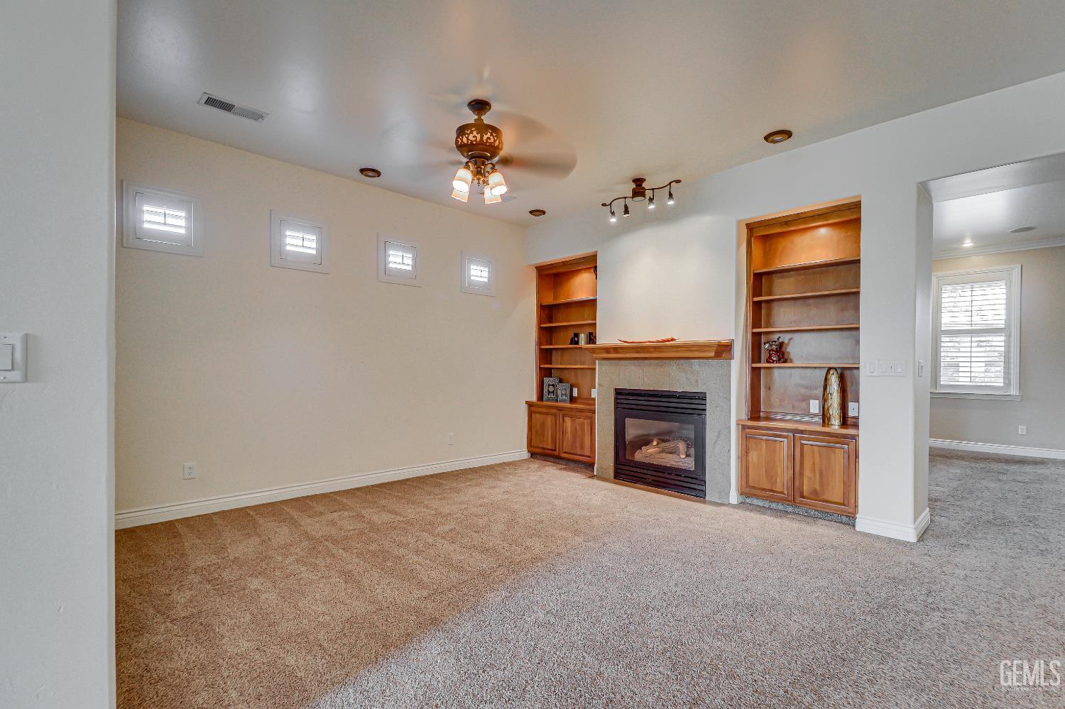 Undisclosed Address Bakersfield, CA 93311 - Photo 12 of 41 a view of a livingroom with a fireplace a chandelier and entryway