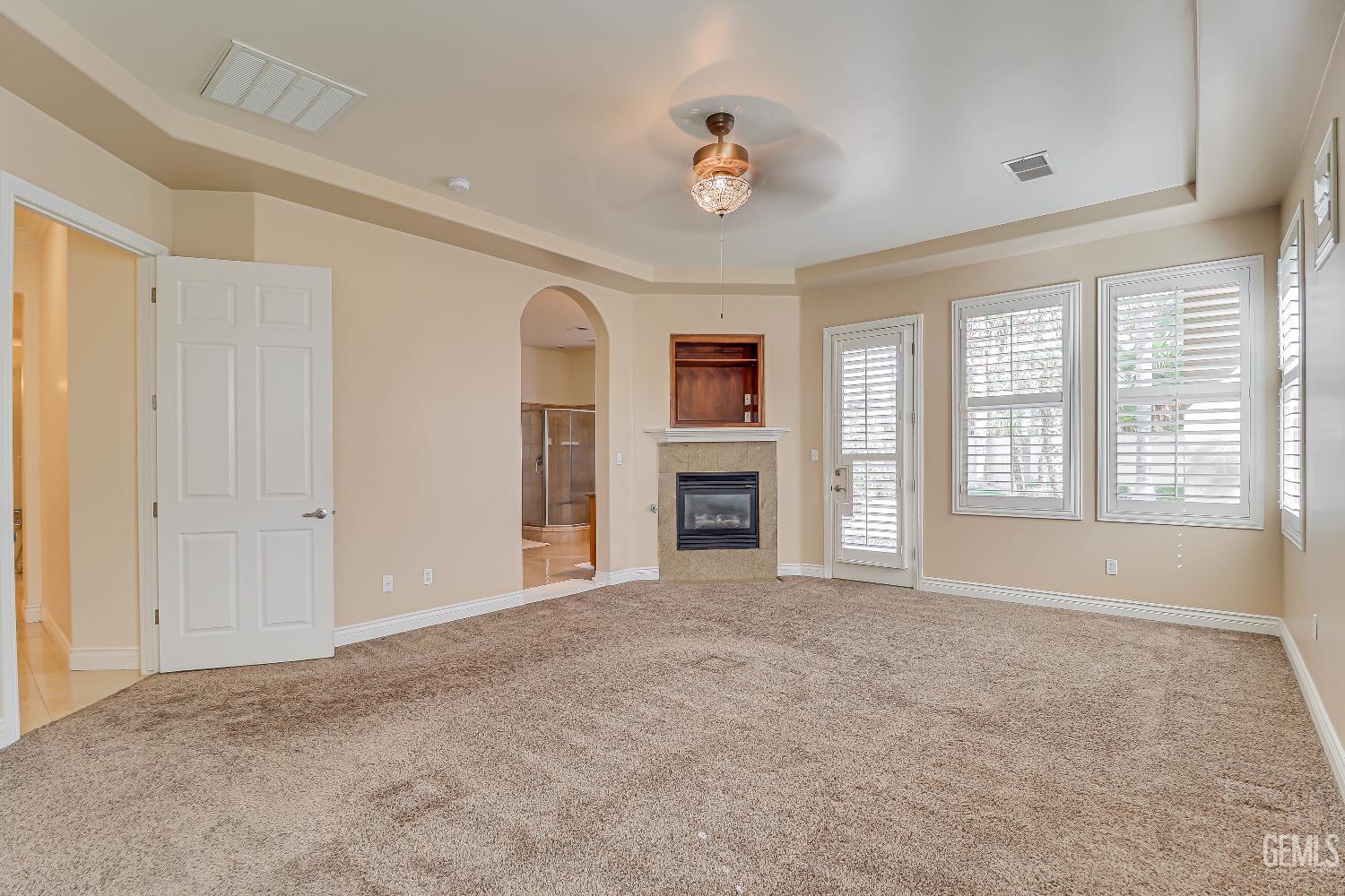 Undisclosed Address Bakersfield, CA 93311 - Photo 2 of 41 a view of an empty room with a fireplace and a window