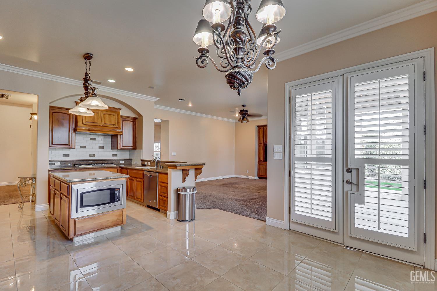 Undisclosed Address Bakersfield, CA 93311 - Photo 22 of 41 a large kitchen with a large center island and stainless steel appliances