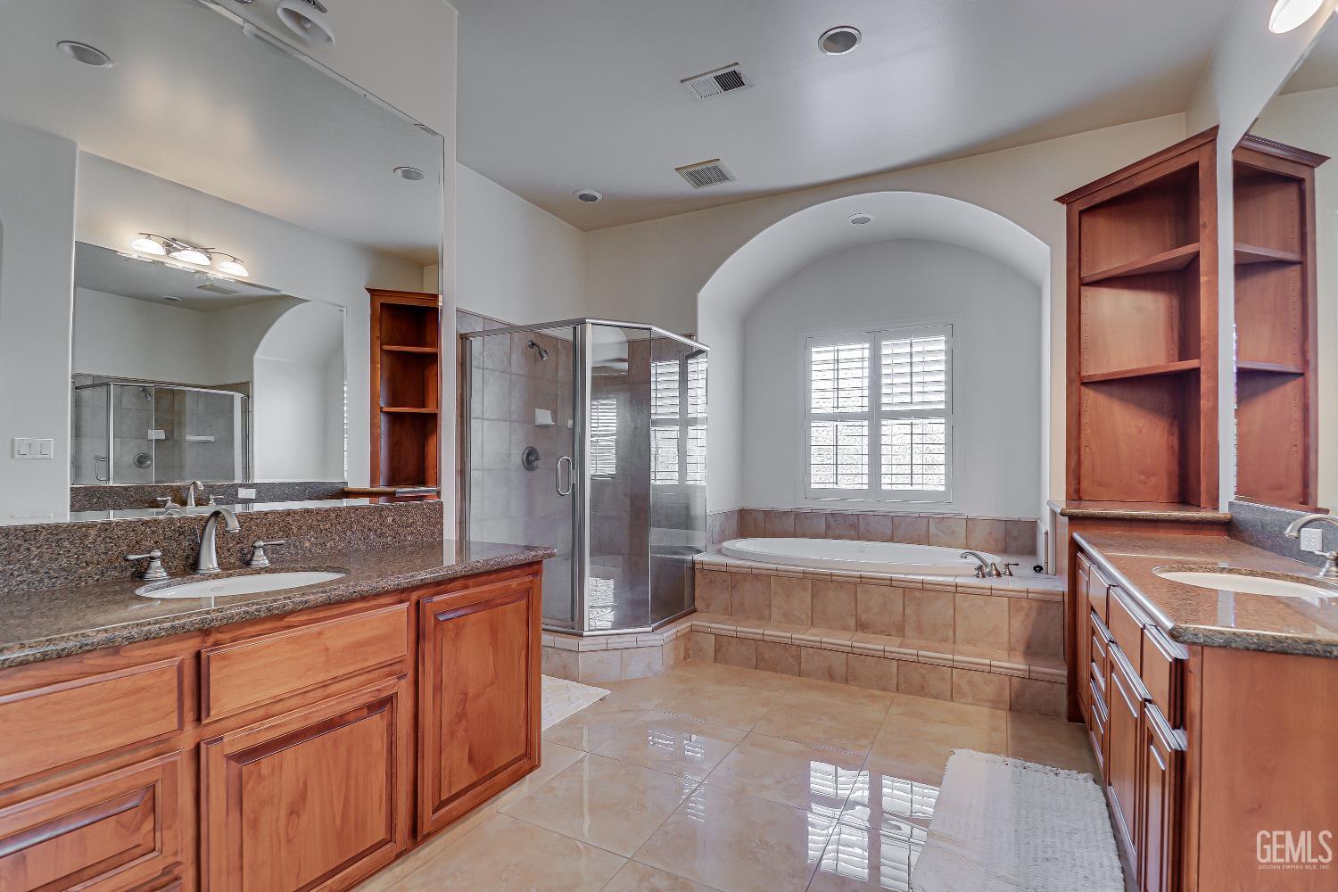 Undisclosed Address Bakersfield, CA 93311 - Photo 3 of 41 a spacious bathroom with a granite countertop tub sink a mirror and shower