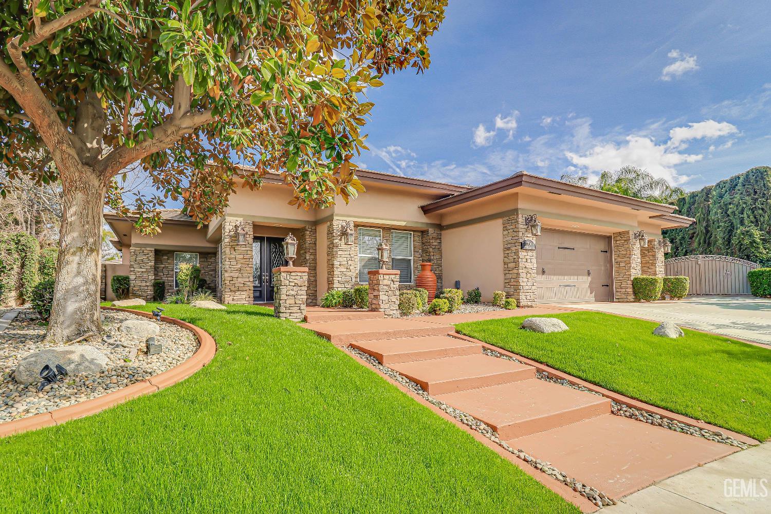 Undisclosed Address Bakersfield, CA 93311 - Photo 7 of 41 a front view of a house with a yard and porch