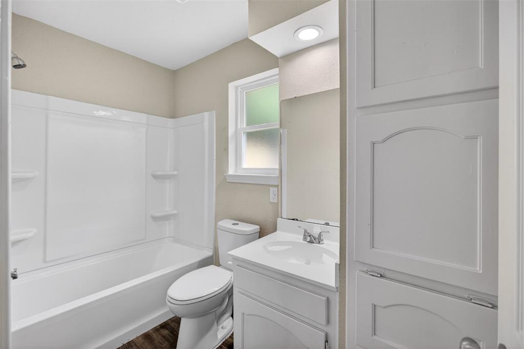 7528 Meadowlark Lane North Watauga, TX 76148 - Photo 14 of 31 a bathroom with a sink a toilet and shower