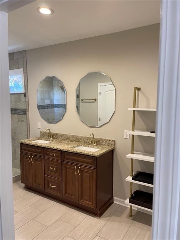 3544 College Street Atlanta, GA 30337 - Photo 6 of 17 a bathroom with a double vanity sink and a mirror