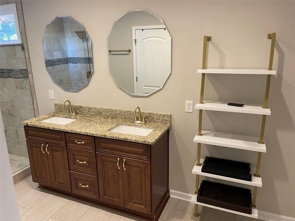 3544 College Street Atlanta, GA 30337 - Photo 10 of 17 a bathroom with a double vanity sink and a mirror