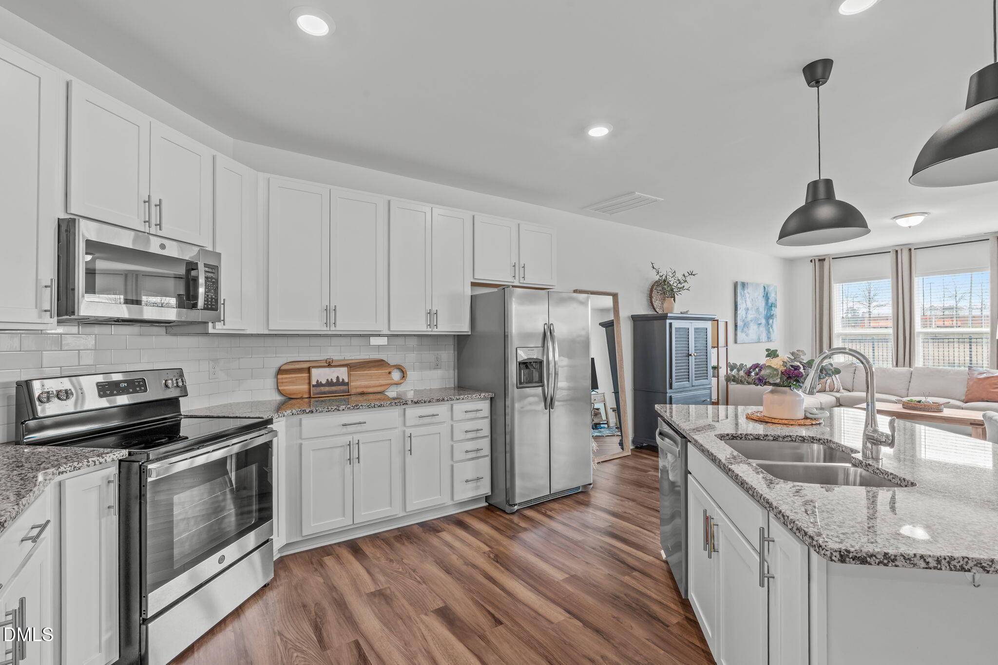 207 Marbella Grove Durham, NC 27713 - Photo 12 of 48 a kitchen with stainless steel appliances granite countertop a sink stove and refrigerator