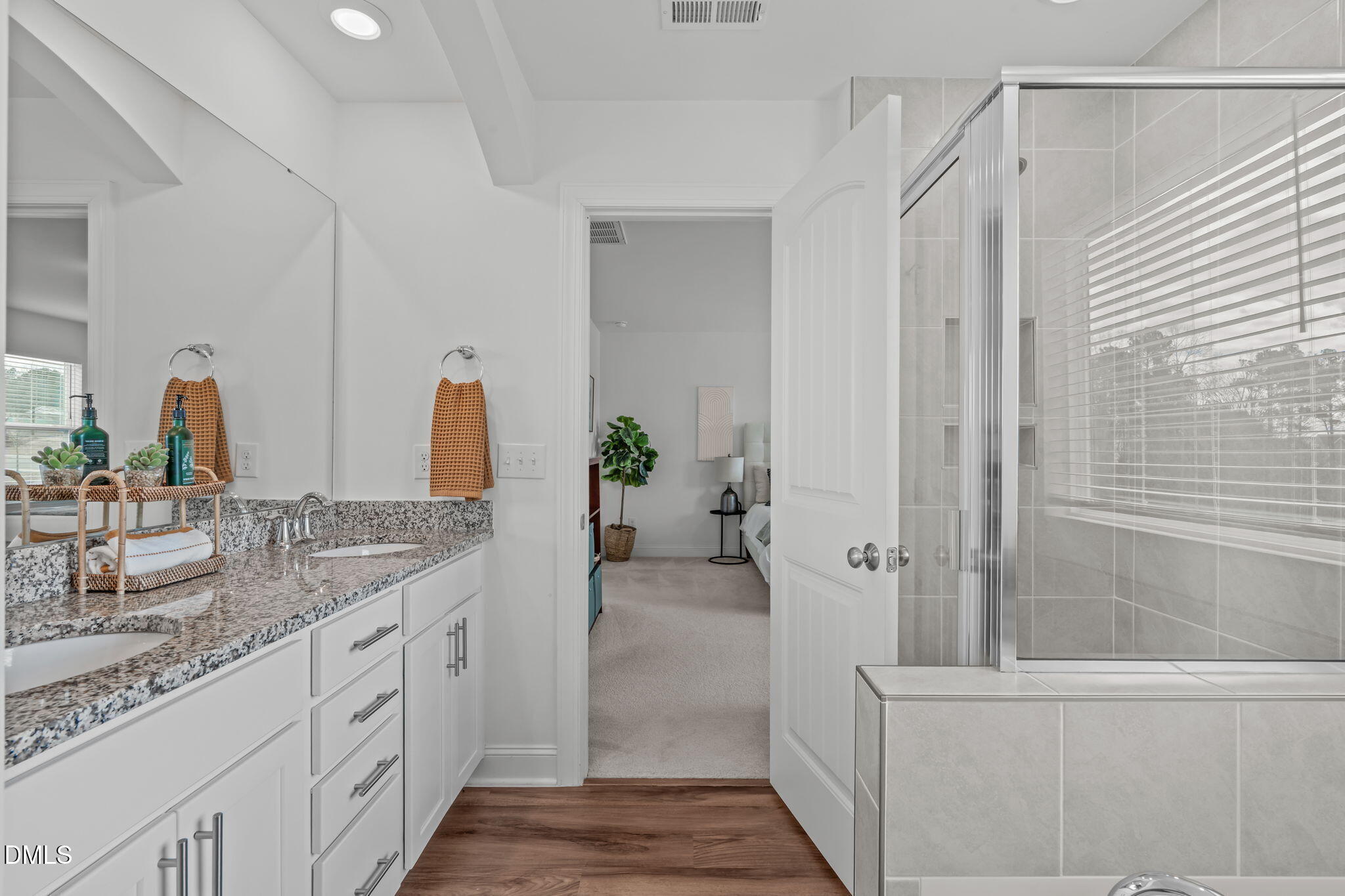 207 Marbella Grove Durham, NC 27713 - Photo 32 of 48 a bathroom with a double vanity sink a mirror and shower