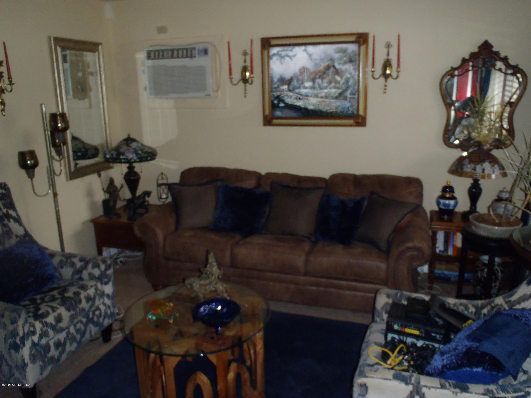 5535 Beney Road Jacksonville, FL 32207 - Photo 8 of 25 a living room with furniture a rug and a chandelier