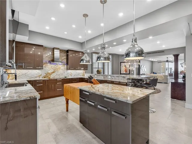 a large kitchen with a large counter top appliances and cabinets
