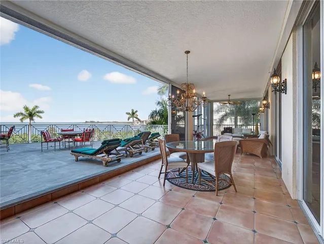 a bedroom with furniture and large windows