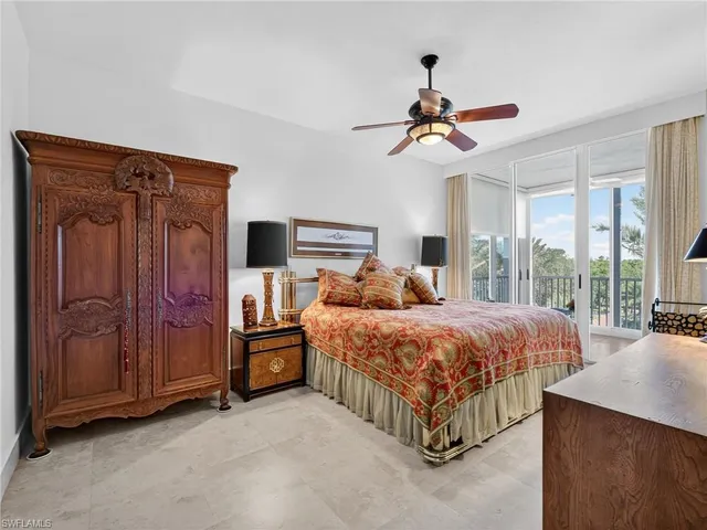 a bedroom with a bed dresser and a flat screen tv