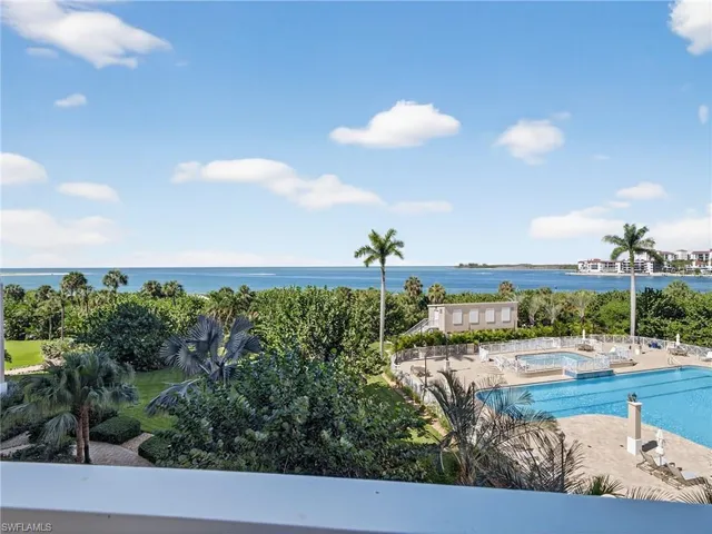 a view of a balcony with chairs and potted plants