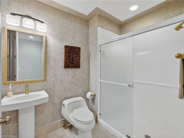 a living room with patio furniture and a chandelier