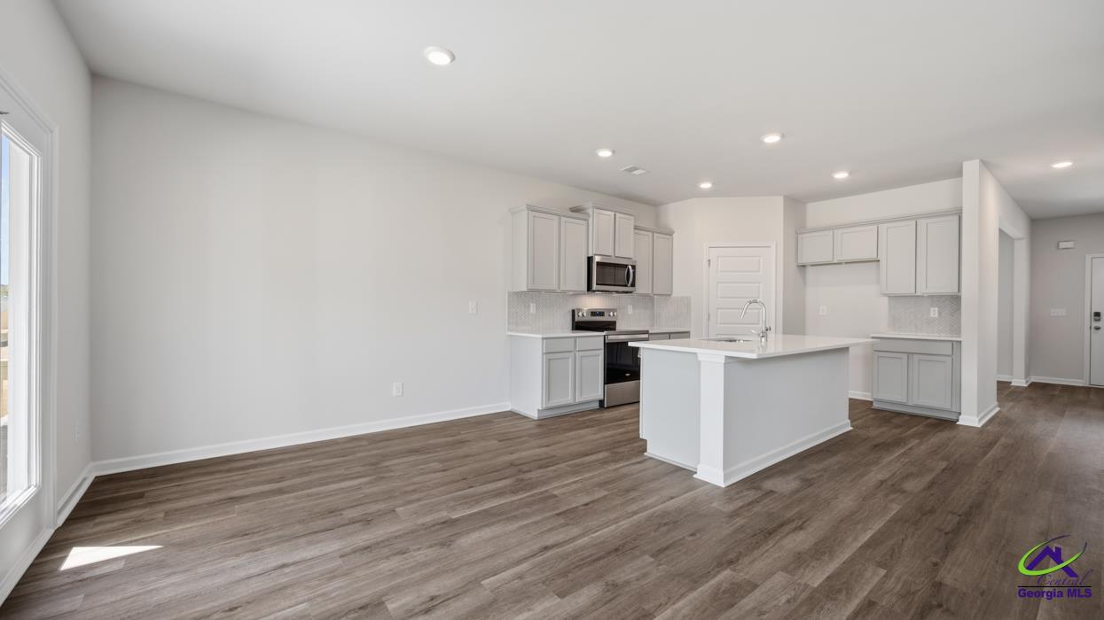 227 Cattle Drive Perry, GA 31069 - Photo 9 of 40 a kitchen with white cabinets and stainless steel appliances