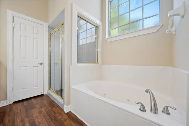 a bathroom with a bathtub and a window