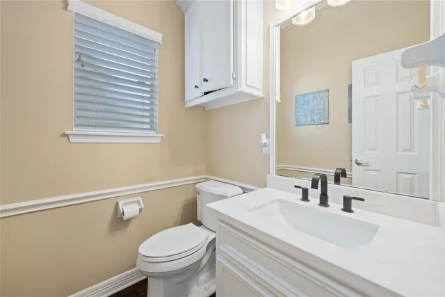 a bathroom with a sink a toilet and vanity