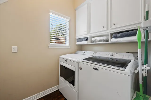 a kitchen with a stove and white cabinets