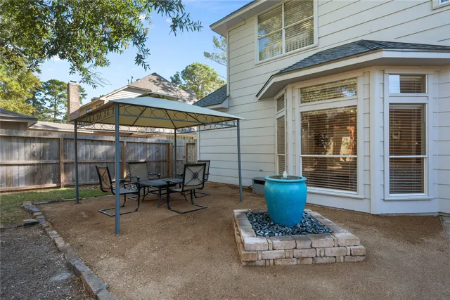 a view of a patio with table and chairs under an umbrella